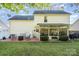 The backyard features a patio, sunroom, green lawn, and white vinyl siding at 12421 Poplar Forest Dr, Charlotte, NC 28278