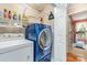 This laundry room includes modern machines, wire racks, and a peek into the workout room at 12421 Poplar Forest Dr, Charlotte, NC 28278
