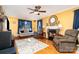 Inviting living room with hardwood floors, a fireplace, comfortable seating, and ample natural light from the large windows at 12421 Poplar Forest Dr, Charlotte, NC 28278