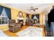 Inviting living room with hardwood floors, a fireplace, comfortable seating, and ample natural light from the large windows at 12421 Poplar Forest Dr, Charlotte, NC 28278
