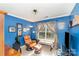 This office features bold blue walls, crown molding, and a comfy leather chair at 12421 Poplar Forest Dr, Charlotte, NC 28278