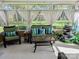 Enclosed sun room with wicker furniture, a decorative waterfall, and a view of the backyard at 12421 Poplar Forest Dr, Charlotte, NC 28278