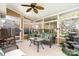 Bright sunroom with lots of windows, a ceiling fan, and comfortable seating, leading to an outdoor space at 12421 Poplar Forest Dr, Charlotte, NC 28278