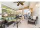 Bright sunroom with lots of windows, a ceiling fan, and comfortable seating, leading to an outdoor space at 12421 Poplar Forest Dr, Charlotte, NC 28278