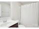 Bathroom featuring a shower-tub combo with white shower curtain, toilet, sink, and granite countertop at 12461 Bryton Ridge Pkwy, Huntersville, NC 28078