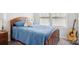 Comfortable bedroom features a cozy blue quilt and a wooden frame bed near a window at 12461 Bryton Ridge Pkwy, Huntersville, NC 28078