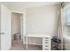 Bright bedroom features a white desk and view to hallway and doorway at 12461 Bryton Ridge Pkwy, Huntersville, NC 28078