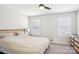 Cozy bedroom with neutral tones, carpeted floors, ceiling fan, and plenty of natural light at 12461 Bryton Ridge Pkwy, Huntersville, NC 28078