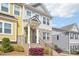 Townhome featuring a brick facade, light gray siding, and an inviting covered porch at 12461 Bryton Ridge Pkwy, Huntersville, NC 28078