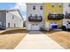 The back exterior of modern townhomes shows driveways and private attached garages and decks at 12461 Bryton Ridge Pkwy, Huntersville, NC 28078