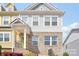 Exterior elevation of a townhome featuring brick facade, light gray siding, and covered porch at 12461 Bryton Ridge Pkwy, Huntersville, NC 28078