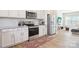 Bright kitchen with stainless steel appliances, white cabinets, and granite countertops at 12461 Bryton Ridge Pkwy, Huntersville, NC 28078