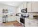 Well-lit kitchen with white cabinetry, stainless steel appliances, and granite countertops at 12461 Bryton Ridge Pkwy, Huntersville, NC 28078