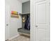 Mudroom with hooks, coats and storage cubbies next to two white doors at 12461 Bryton Ridge Pkwy, Huntersville, NC 28078