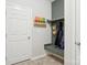 Functional mudroom with hooks and storage for coats, beside white door at 12461 Bryton Ridge Pkwy, Huntersville, NC 28078