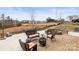 The backyard features a brick patio and a landscaped area with beautiful trees at 12614 Chantrey Way, Huntersville, NC 28078