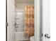 Bright bathroom featuring a shower over tub with a patterned curtain at 12614 Chantrey Way, Huntersville, NC 28078
