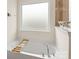 Relaxing bathroom featuring a soaking tub, frosted window, and chrome fixtures at 12614 Chantrey Way, Huntersville, NC 28078