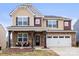 Charming two-story home with stone accents, covered porch, and a two-car garage at 12614 Chantrey Way, Huntersville, NC 28078