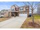 Attractive front exterior showcasing a two-story home with a well-maintained lawn at 12614 Chantrey Way, Huntersville, NC 28078