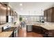 Spacious kitchen with stainless steel appliances, granite countertops, and dark wood cabinetry at 12614 Chantrey Way, Huntersville, NC 28078