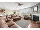 Open-concept living room with hardwood floors, fireplace, and large windows at 12614 Chantrey Way, Huntersville, NC 28078