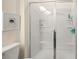 Bathroom shower featuring glass doors, built in shelving and white tile at 12614 Chantrey Way, Huntersville, NC 28078