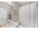 Bathroom with stylish vanity, mirror and shower with white curtain at 1323 Stack Rd, Monroe, NC 28112