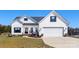 Charming two-story home with white siding, black shutters and a well-manicured lawn at 1323 Stack Rd, Monroe, NC 28112