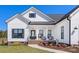 Charming exterior showing a covered porch with chairs and decorative planters near the main entry at 1323 Stack Rd, Monroe, NC 28112