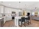 Modern kitchen featuring white cabinets, stainless appliances, island with seating, and open layout to the living area at 1323 Stack Rd, Monroe, NC 28112