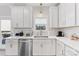 Modern kitchen with stainless steel appliances, white cabinets, light countertops, and under cabinet lighting at 1323 Stack Rd, Monroe, NC 28112