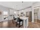 Bright kitchen boasts white cabinetry, stainless steel appliances, and a center island with pendant lighting at 1323 Stack Rd, Monroe, NC 28112