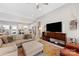 Bright and airy living space with a view of the modern kitchen and hardwood floors at 1323 Stack Rd, Monroe, NC 28112