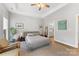 Well-lit bedroom featuring a neutral palette, tray ceiling, a ceiling fan and an ensuite bathroom at 1323 Stack Rd, Monroe, NC 28112