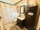 Functional bathroom featuring a shower-tub combo, vanity, and storage shelves at 134 Weaver Hill Dr, Statesville, NC 28625