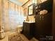 Well-lit bathroom with a vanity, toilet, and shower-tub combo at 134 Weaver Hill Dr, Statesville, NC 28625