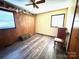 Bedroom with hardwood floors, wood paneling, and natural light at 134 Weaver Hill Dr, Statesville, NC 28625