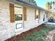 Close-up of home's exterior features, including brick, garden bed, and wooden shutters at 134 Weaver Hill Dr, Statesville, NC 28625