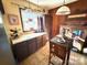 A kitchen with dark wood cabinets, a small window, tile flooring and an eat in space at 134 Weaver Hill Dr, Statesville, NC 28625