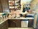 Galley kitchen featuring dark cabinets, stainless steel appliances, and ample counter space at 134 Weaver Hill Dr, Statesville, NC 28625