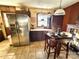 View of the kitchen with stainless steel refrigerator, dining area, and tile floors at 134 Weaver Hill Dr, Statesville, NC 28625