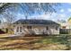 The backyard features double doors and a concrete patio at 13701 Dawlish Ln, Pineville, NC 28134