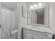 This bathroom features a white marble vanity and a shower with a patterned curtain at 13701 Dawlish Ln, Pineville, NC 28134