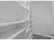 White shelving and carpet flooring creates an organized walk-in closet space at 13701 Dawlish Ln, Pineville, NC 28134