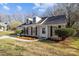 Charming home featuring dormer windows, shutters and a manicured lawn at 13701 Dawlish Ln, Pineville, NC 28134