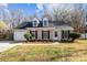 Charming one-story home with a manicured lawn, dormer windows, and attached garage at 13701 Dawlish Ln, Pineville, NC 28134