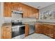 Kitchen showcasing stainless steel appliances, granite countertops, and wood cabinets at 13701 Dawlish Ln, Pineville, NC 28134