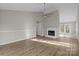Bright living room boasts hardwood floors, a fireplace, and high ceilings at 13701 Dawlish Ln, Pineville, NC 28134