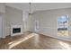 Spacious living room boasting hardwood floors, a vaulted ceiling, and a cozy fireplace at 13701 Dawlish Ln, Pineville, NC 28134